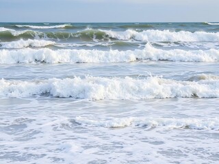 Large ocean waves lapping at the shore during a strong afternoon wind, beach cleanup, stormy weather, rough seas