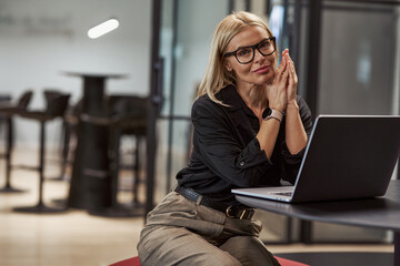 A Young Professional Woman Engaged in Her Work at a Modern Office Space Environment © Daria