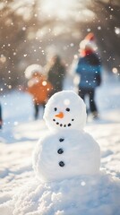 Fototapeta premium Children building a snowman in snowy alpine landscape