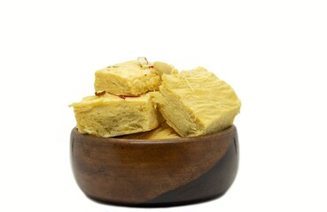 Soan Papdi or Shompapri Garnished with Cashew Nut, Pistachio, Almond and Saffron in Wooden Bowl Isolate on White Background with Copy Space, Also Known as Patisa or Shonpapdi
