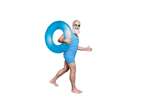 Full length profile side photo of lovely retired man with eyewear eyeglasses holding toy ring moving wearing striped swim wear isolated over blue background