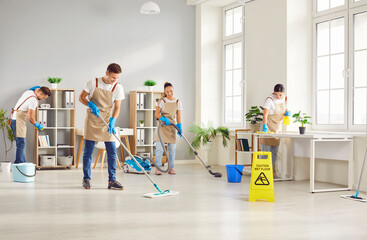 Obraz premium Cleaning service staff, armed with mops and vacuums, works in a coordinated team to bring cleanliness to home or office. Expert cleaners team to transform space into a pristine environment.
