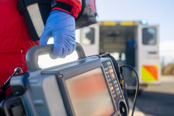 Emergency medical service. Close-up of paramedic hand in blue surgical gloves while running with...