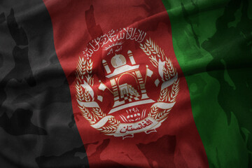 colourful waving flag of afghanistan on the old army khaki texture background. military concept.