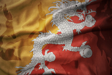 colourful waving flag of bhutan on the old army khaki texture background. military concept.