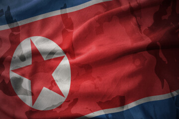 colourful waving flag of north korea on the old army khaki texture background. military concept.