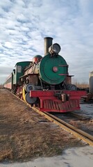 Obraz premium Vintage Steam Locomotive on Railroad Tracks