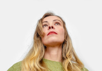 Naklejka premium Dreamy woman with healthy wavy long blonde hair. Calm makeup and red lipstick. Looking up. High quality.