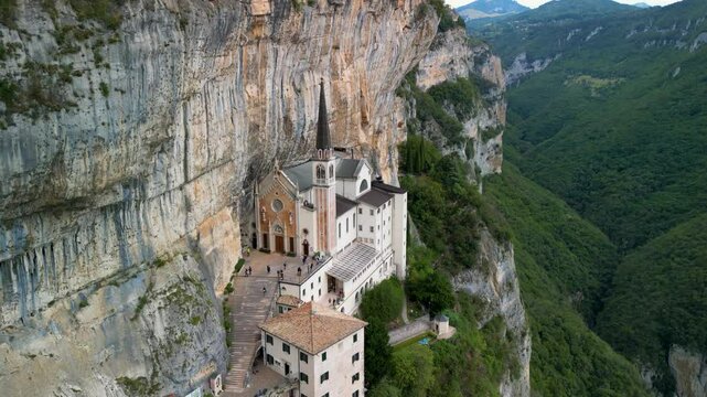 Panoramic aerial view of the Sanctuary of the Madonna della Corona, the church of Spiazzi, Caprino Veronese on the Monte Baldo massif, high above the Adige Valley, Italy