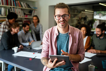Group of business people and software developers working as a team in modern startup office