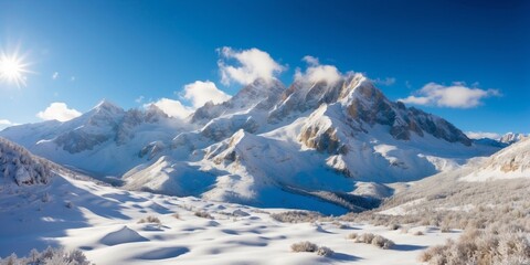 Naklejka premium Snow-covered mountains under a clear blue sky in winter landscape