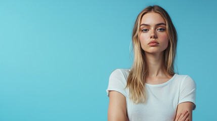 Fototapeta premium Portrait of a young woman standing against a bright blue background
