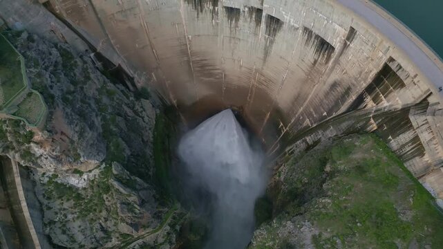 Dam discharges water from the reservoir. Arial view of water outlet from the dam. Howell Bunger valve in operation in vault dam. Quentar Reservoir. Spain.