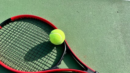 tennis racket and tennis ball on the court