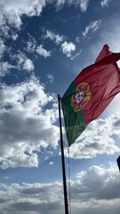 Portugal flag on a sky with clouds