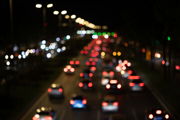 City car taillights and street lights blur out of focus spots