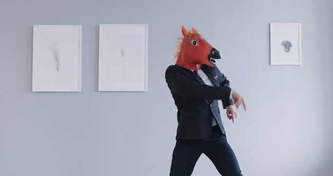 Funny energetic dancing man entertainment, wearing cute horse head mask, formal office suit, animal dance representation for party show fun, strange dancer moving hands, lively amuse performance