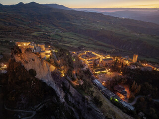 Italy November 24, 2024: aerial view of the village of San Leo with its fortress at sunset. We are in Emilia Romagna in the province of Rimini