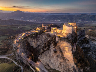 Italy November 24, 2024: aerial view of the village of San Leo with its fortress at sunset. We are...