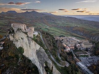 Italy November 24, 2024: aerial view of the village of San Leo with its fortress at sunset. We are...