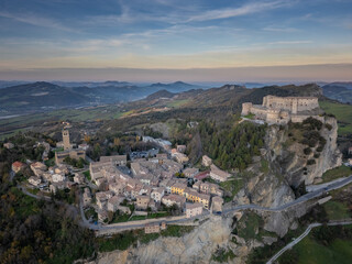 Italy November 24, 2024: aerial view of the village of San Leo with its fortress at sunset. We are...