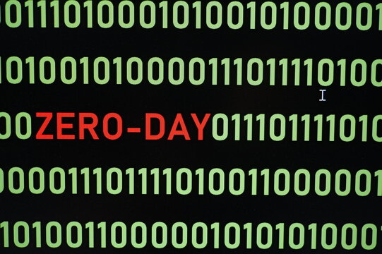 ZERO-DAY text and binary code concept from the desktop computer screen,ZERO-DAY vulnerability concept (also known as a 0-day)A zero-day vulnerability is a flaw in software or hardware.