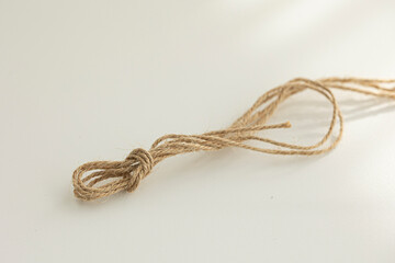 brown string is laying on a white background.