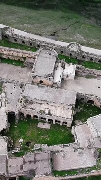 Aerial tilt shot of the roof of Krak des Chevaliers medieval castle in Syria, vertical video.