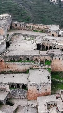 Krak des Chevaliers Crusader castle Closeup aerial view Homs Syria, vertical video.