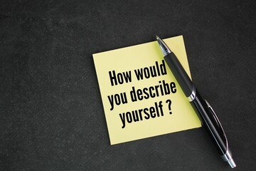 pen and colored paper with the question How would you describe yourself?