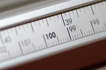 Detail of a wood cutting machine ruler with focus on the figure 100