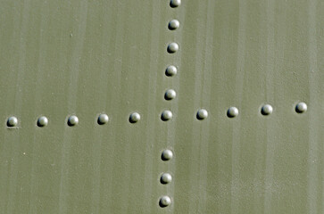 Riveted military green metal.