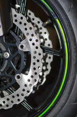 Close up view of motorcycle front wheel.