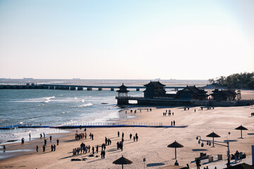 Aerial view of Chinese beach with unrecognizable people in Qinhuangdao. This area is famous because it is the beginning of the Great Wall of China, known as the Old Dragon's Head.