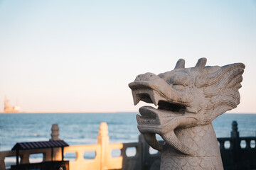 Dragon sculpture on buddhist temple on the beach with the sea in the background on a sunny day at...