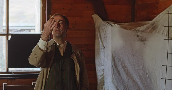 A secret agent dressed in a trench coat grabs a pill from his pocket and talks about it. The spy throws the capsule to someone else