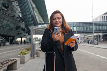 Smiling female business professional hailing taxi. Happy businesswoman waiting for taxi on the city street. High quality photo