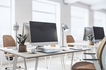 Perspective view on stylish work place in spacious sunny office with modern laptop, lamp, flowerpot and notes on light wooden table, brown and white chair on big window background. 3D rendering