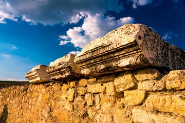 Ancient stone ruins beneath a vibrant sky.