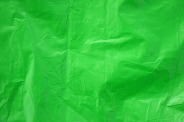 Fototapeta premium Texture of Green color plastic bag smooth crumpled surface