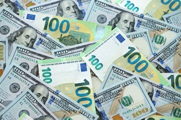 Big pile of Euro and USD banknotes. Many european and united states dollars