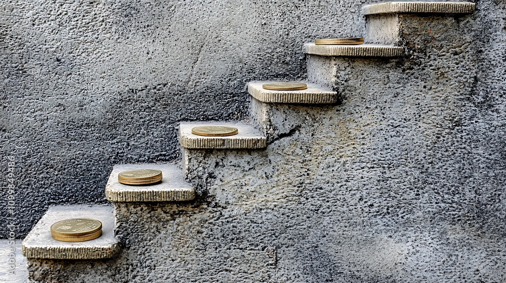Aufkleber A symbolic image of stairs labeled small savings medium savings and emergency fund with coins placed on each step Stock Photo with side copy space