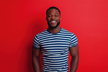 Obraz premium A man with a big smile on his face is wearing a striped shirt