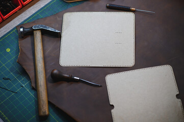 Crafting tools on natural cow leather in the tailoring workshop. Top view