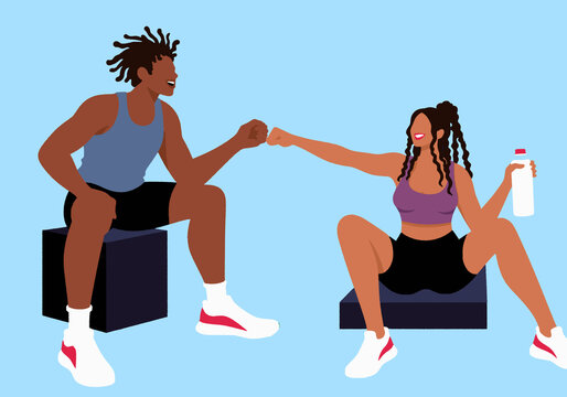 Young man and woman giving fist bump against blue background