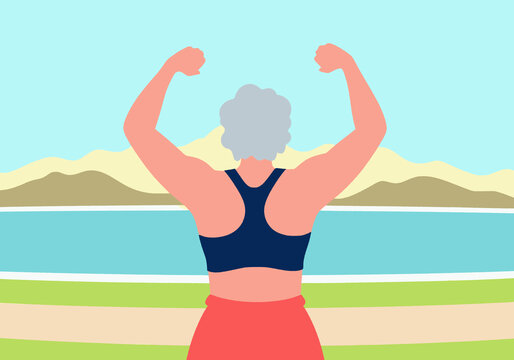 Woman showing muscular build and exercising at beach