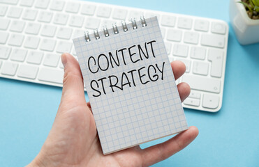 Content strategy, text on notebook in hand lying on office background