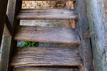 Old wooden staircase to one of buildings in ancient fortress