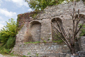 Part of medieval stone defensive wall in autumn overcast morning