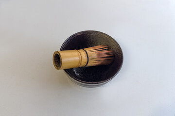 Bamboo whisk for preparing green matcha tea in tea bowl